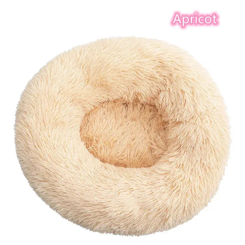 Soft plush round dog and cat bed in apricot color, ideal for calming and anxiety relief naps.