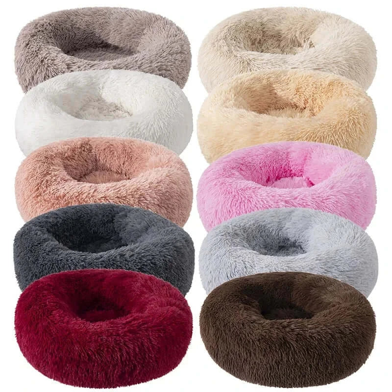 Variety of plush round donut pet beds available in multiple colors for dogs and cats, ideal for comfort and anxiety relief.