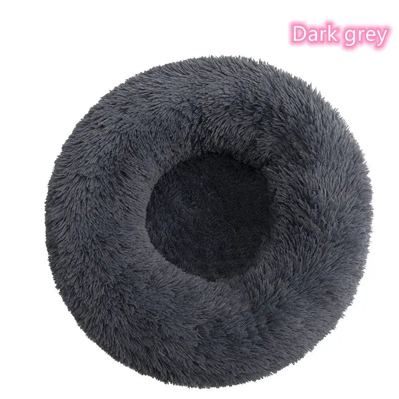 Dark grey plush dog donut bed designed for small pets, offering comfort and anxiety relief for naps and sleep.