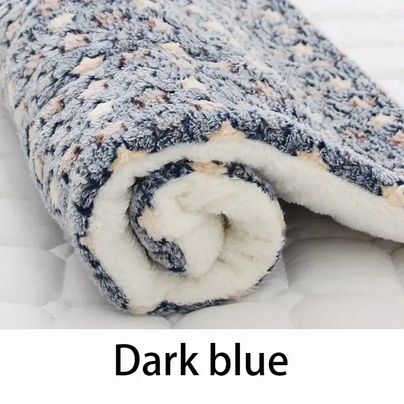 Dark blue flannel pet sleeping mat rolled up, showcasing the soft coral velvet and cozy design for pets.