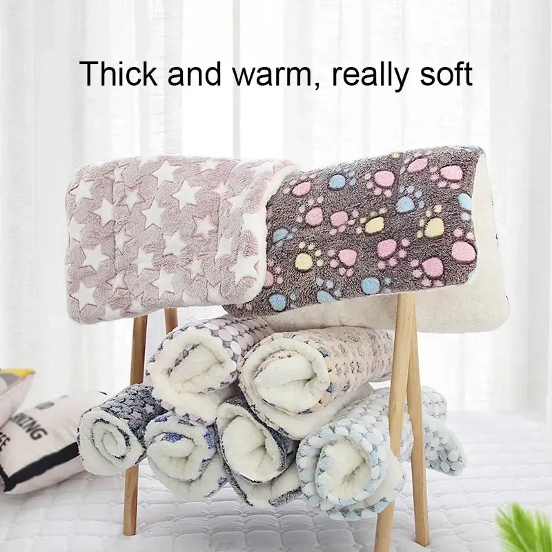 Soft and cozy pet blankets in various patterns, showcasing thick and warm material for ultimate comfort.