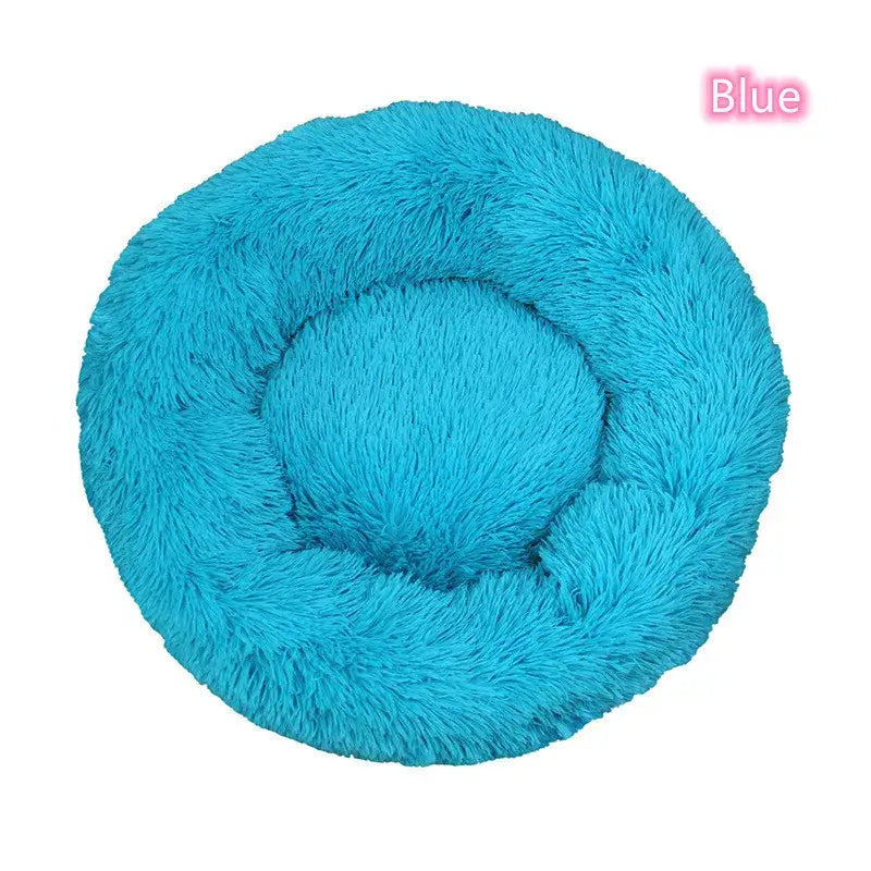 Blue plush round pet bed for small dogs and cats, providing cozy comfort and anxiety relief.