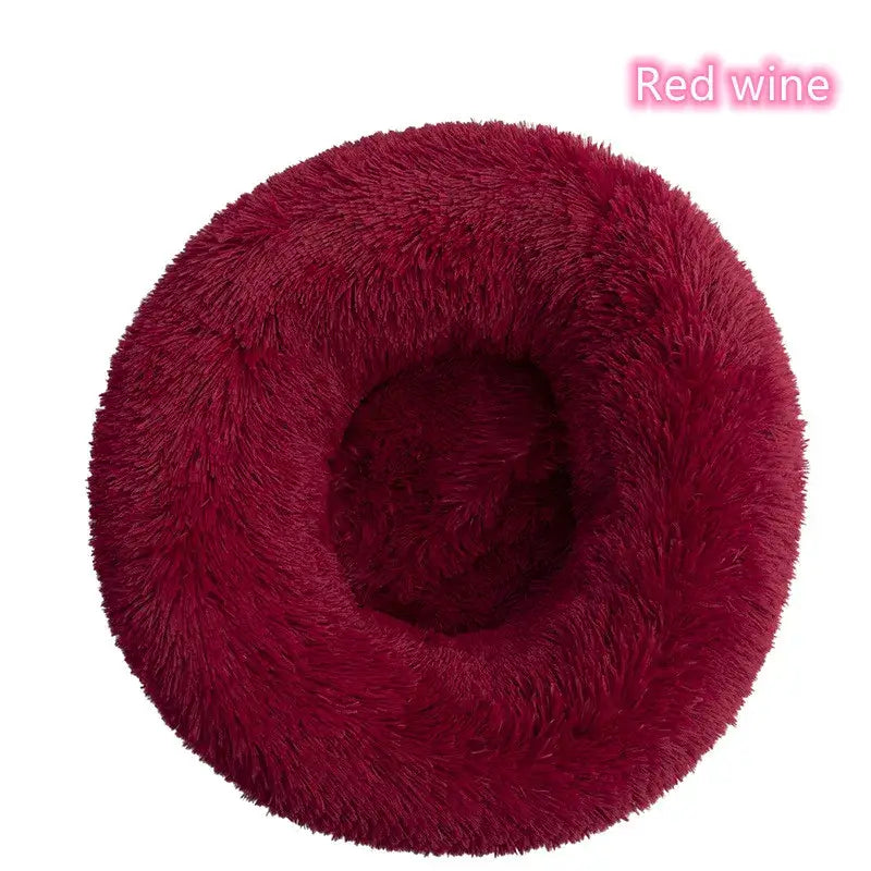 Cozy red wine donut-shaped pet bed for cats and small dogs, offering comfort and anxiety relief.