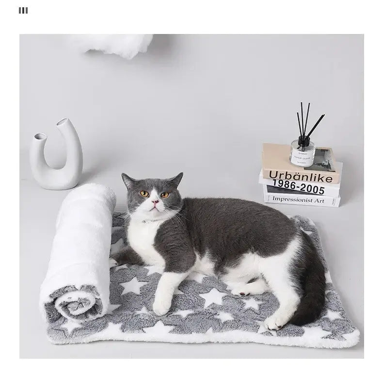 Cozy flannel pet sleeping mat with a cat relaxing on it, featuring a stylish star pattern.