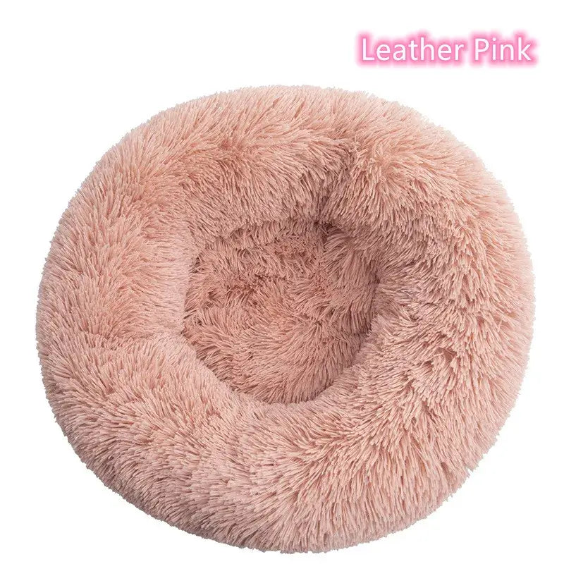 Soft pink round pet bed, perfect for small dogs and cats; plush, cozy, and anxiety-relief design.