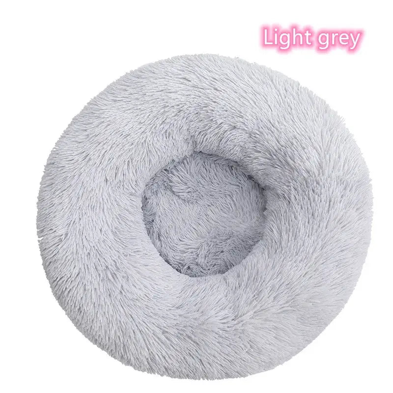 Light grey round plush pet bed for dogs and cats, ideal for calming sleep and anxiety relief.