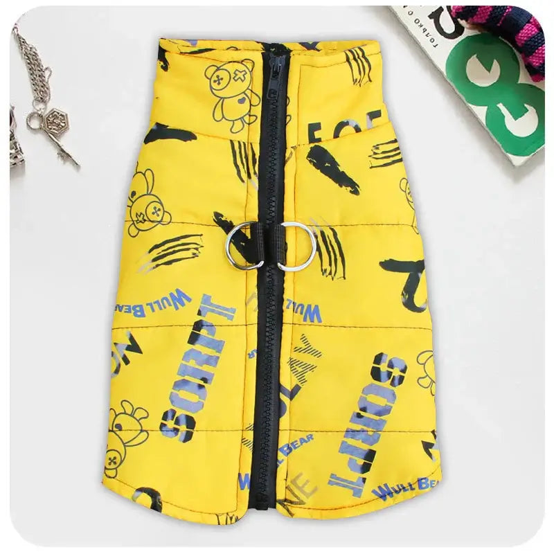 Stylish yellow waterproof dog jacket with unique print, featuring harness buckle for all-weather protection.