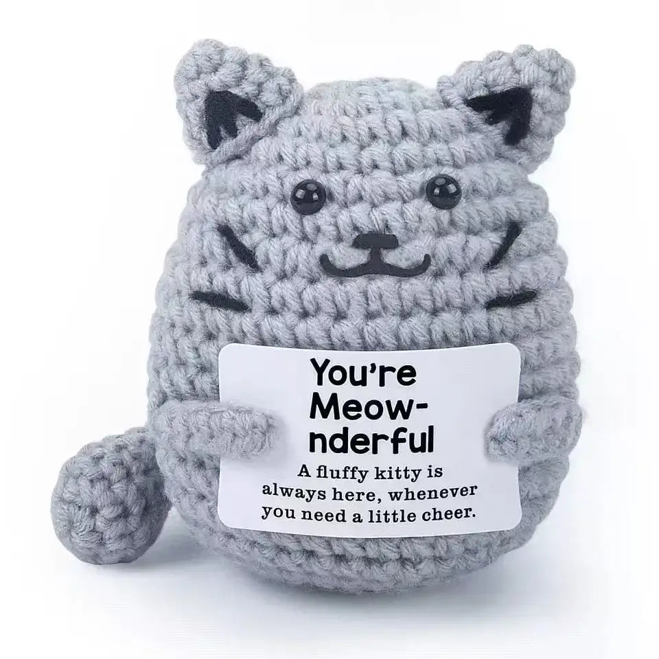Handmade gray crochet cat ornament doll holding a card that says 'You're Meow-nderful', perfect for home decor.
