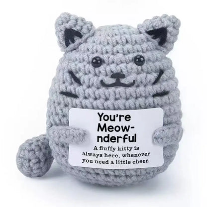 Handmade gray crochet cat ornament doll holding a card that says 'You're Meow-nderful', perfect for home decor.
