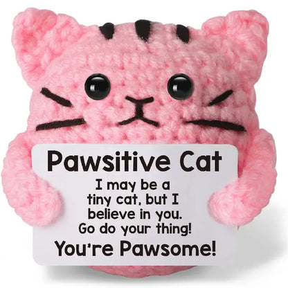 Handmade crochet pink cat doll holding a sign that says "Pawsitive Cat: You're Pawsome!"