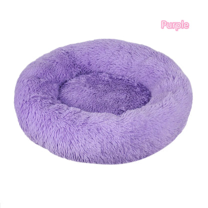 Purple plush round dog and cat bed, perfect for calming pets and reducing anxiety with soft, warm fabric.