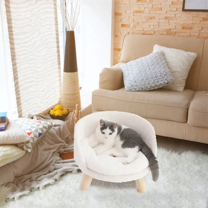 Cozy cat lounging on a luxury plush cat bed with wooden legs in a stylish living room setting.