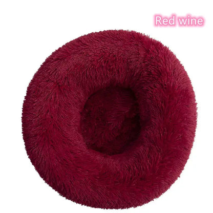Cozy red wine donut-shaped pet bed for cats and small dogs, offering comfort and anxiety relief.
