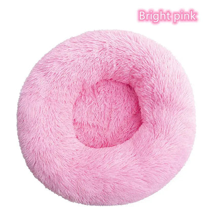 Bright pink round plush pet bed, ideal for small dogs and cats, providing a cozy and calming rest space.