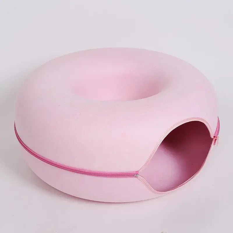 Pink donut-shaped cat bed tunnel with zipper design for cozy lounging and play.
