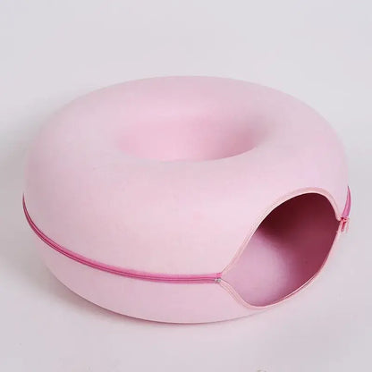 Pink donut-shaped cat bed tunnel with zipper design for cozy lounging and play.