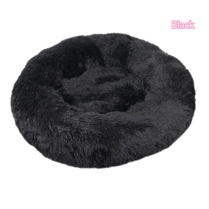 Black plush round donut pet bed for dogs and cats, offering comfort and anxiety relief for small pets.