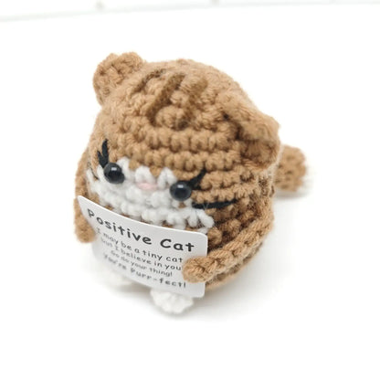 Handmade crochet cat ornament doll holding a sign that says 'Positive Cat' for home decor.